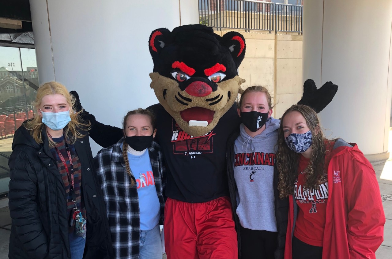 Students posing with the Bearcat mascot