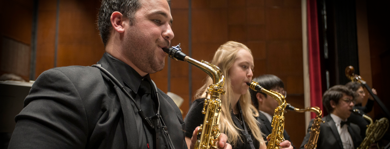 CCM saxophone students performing on stage.