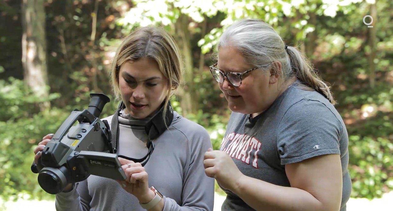 Bloomberg reporter Rachel Adams-Heard and UC associate professor Amy Townsend-Small look at the screen of a video camera.