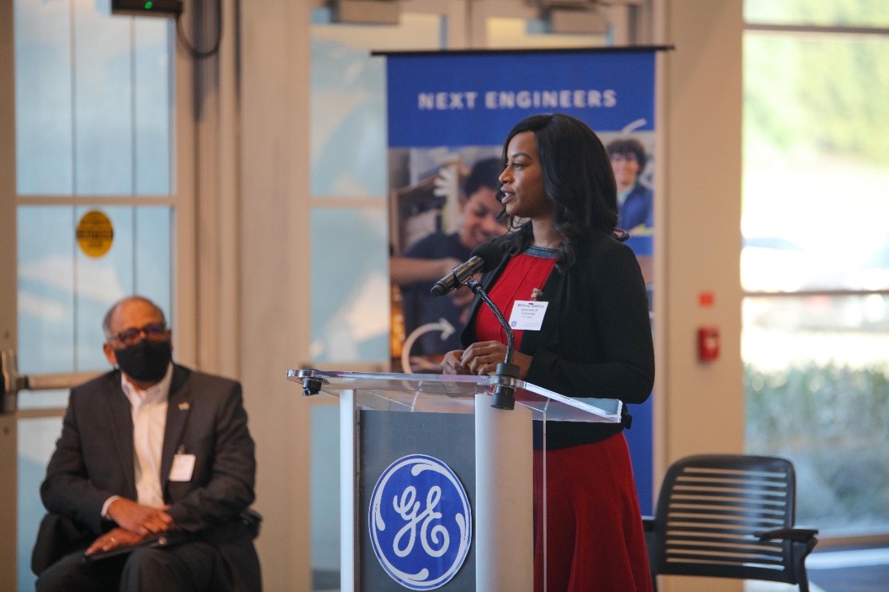 Whitney Gaskins speaks at a podium at GE Aviation's Learning Center.