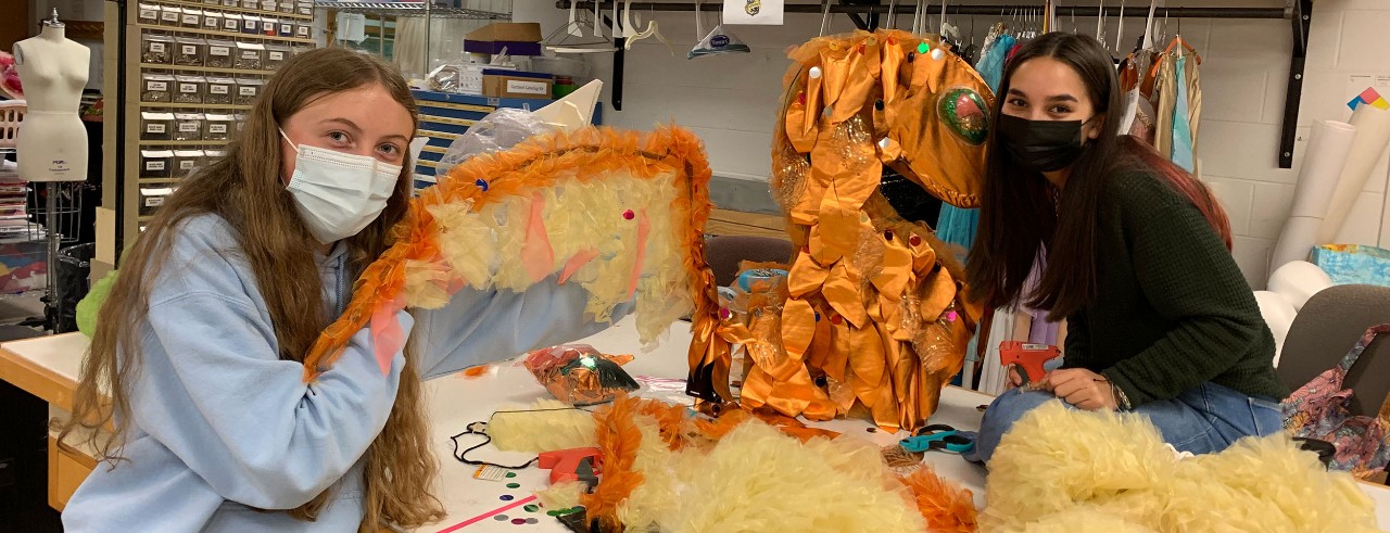 Students work to build a dragon halloween costume