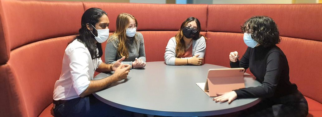 University Innovation Fellows masked at a table