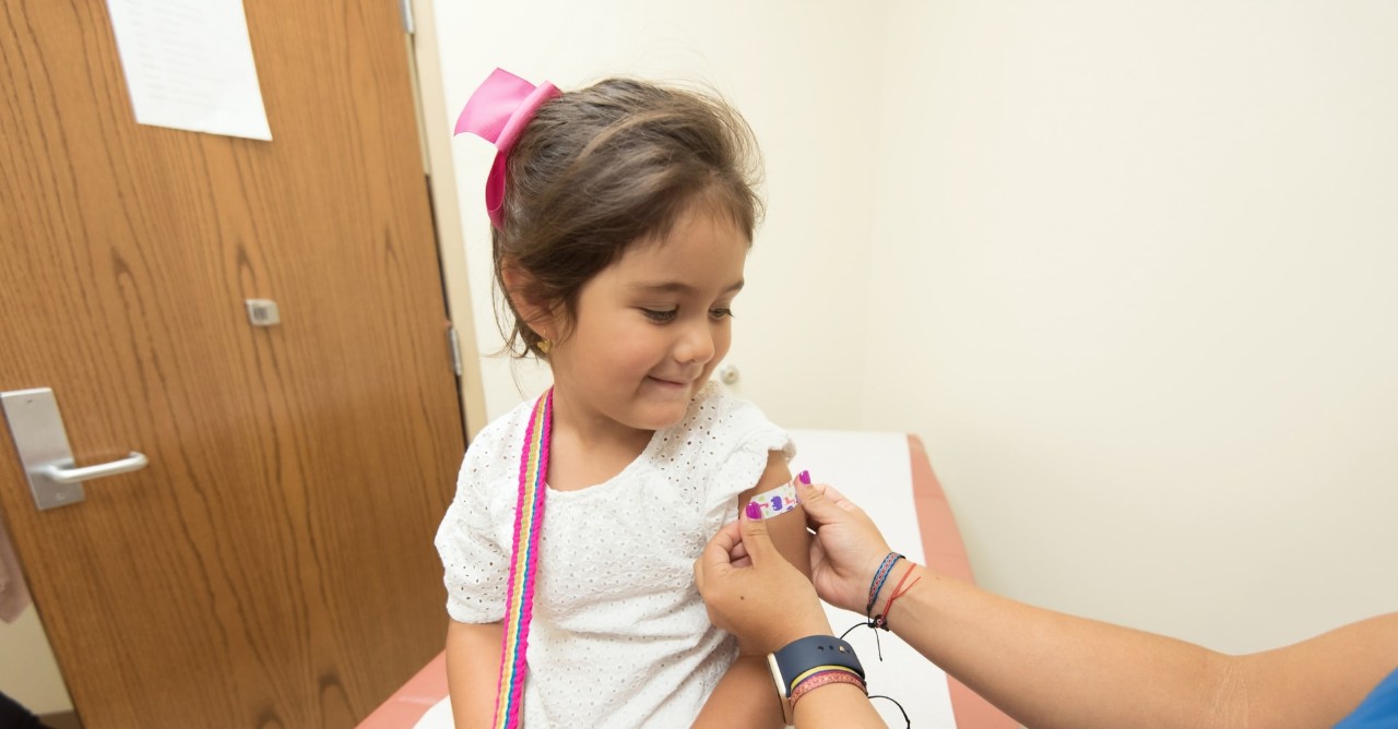 young girl getting a shot at a doctor's office