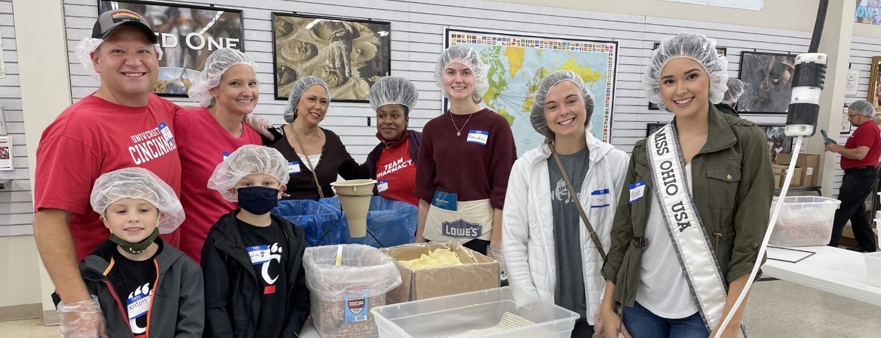 Nicole Wess poses with fellow volunteers packing food at A Child's Hope International