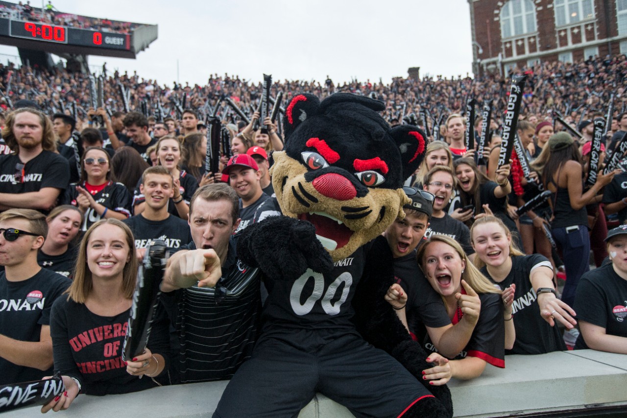 Bearcat mascot and fans at a UC football game