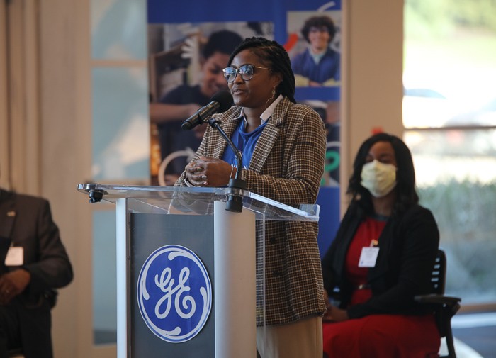 GE engineer Alisha Davis-Kent speaks at a podium during GE's announcement about its Next Engineers initiative. 