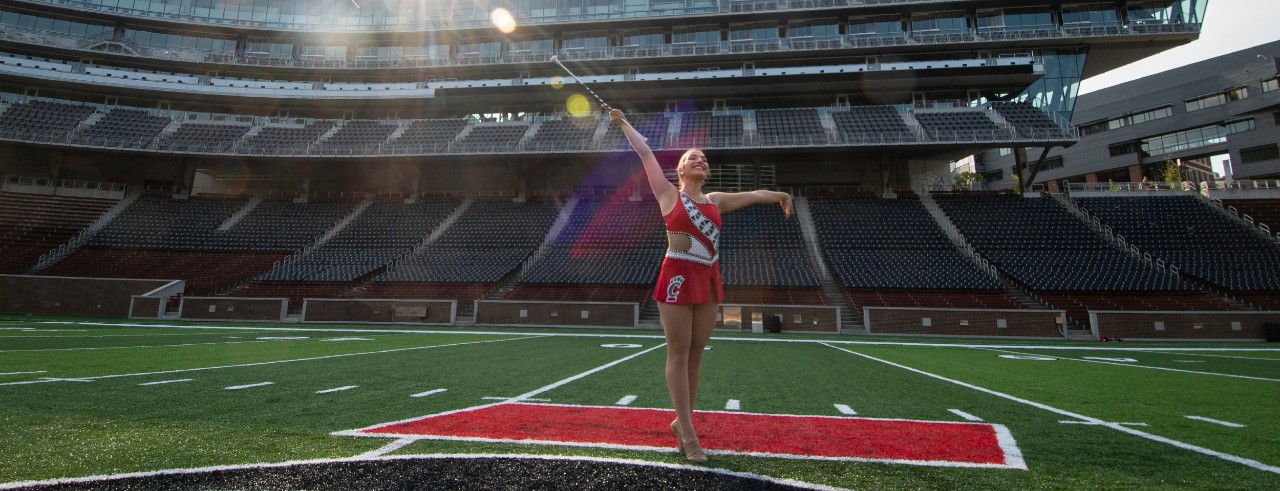 April Gable twirling on Nippert field