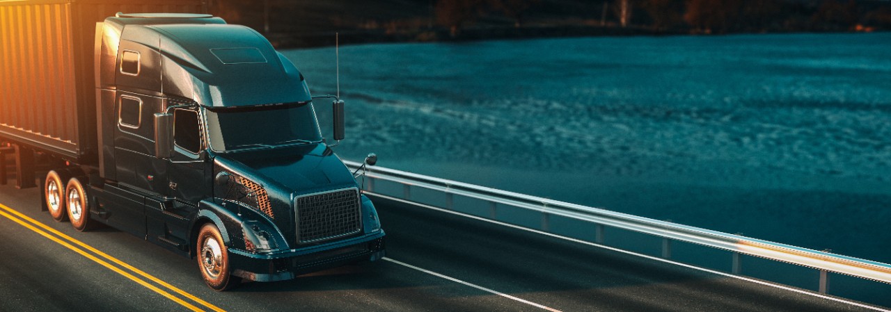 A freight truck drives on the road.