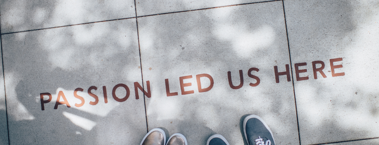 art on sidewalk that reads "Passion led us here"