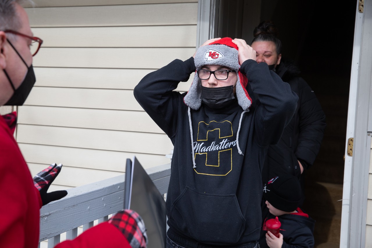 Young man surprised on front porch