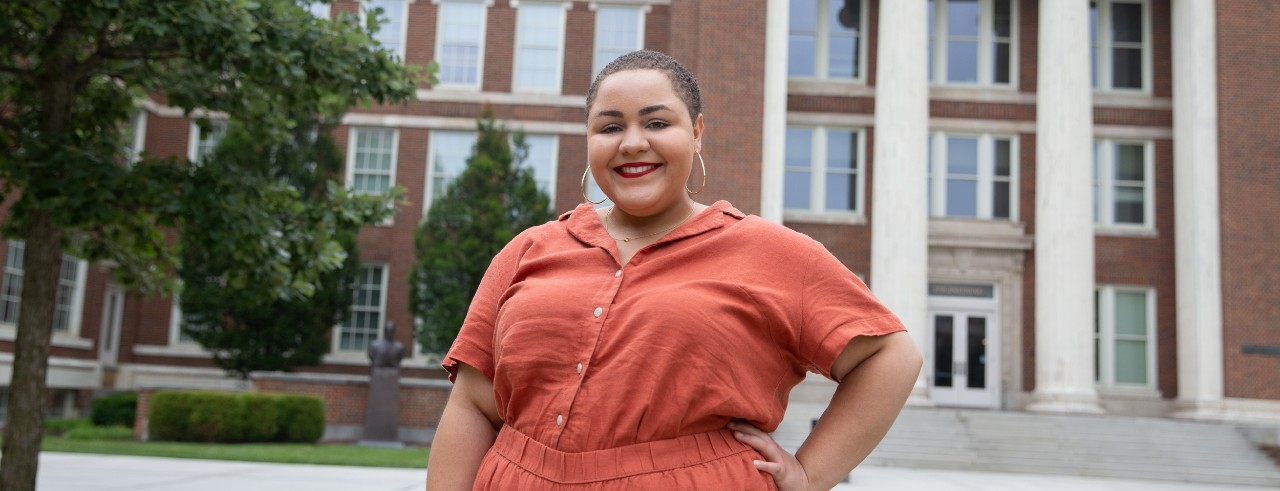 Camryn Morrow poses in front of UC building