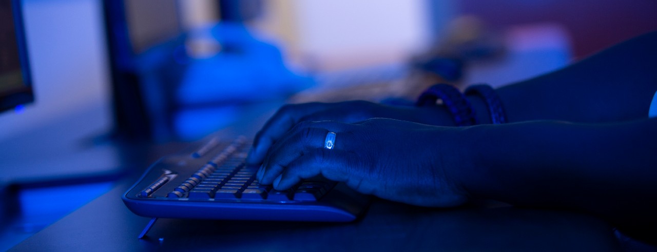 A person types on a keyboard.