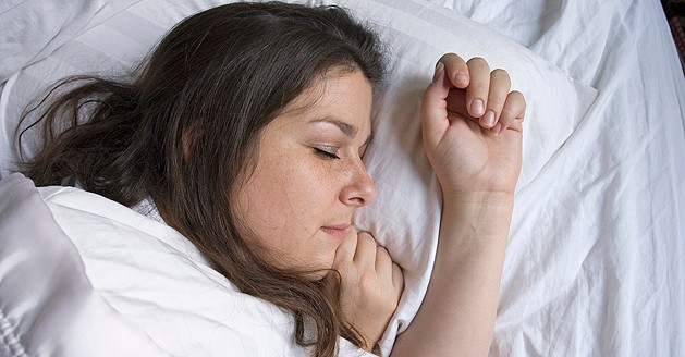 a photo of a woman sleeping in bed