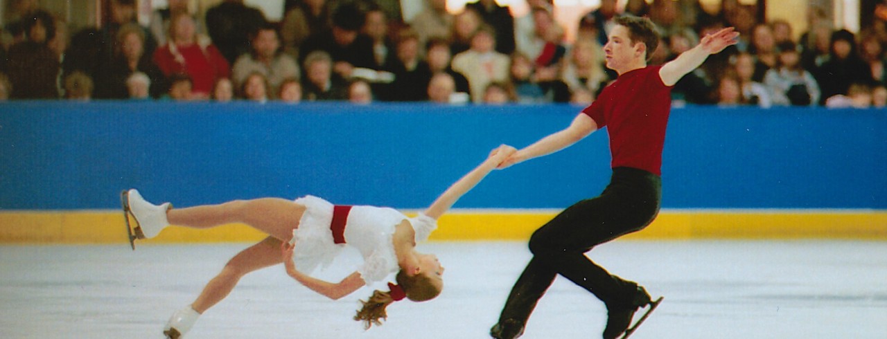Alicia Heelan is held up by her figure skating partner as she glides across the ice upside down