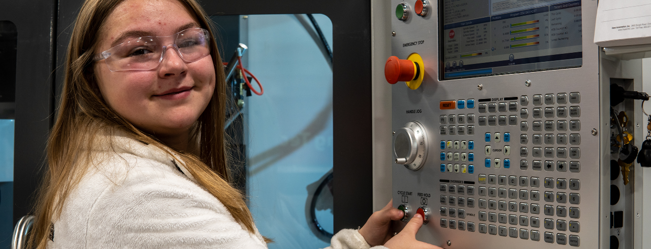 Student Hailey Sampson operates machinery in the UC Clermont manufacturing engineering lab.