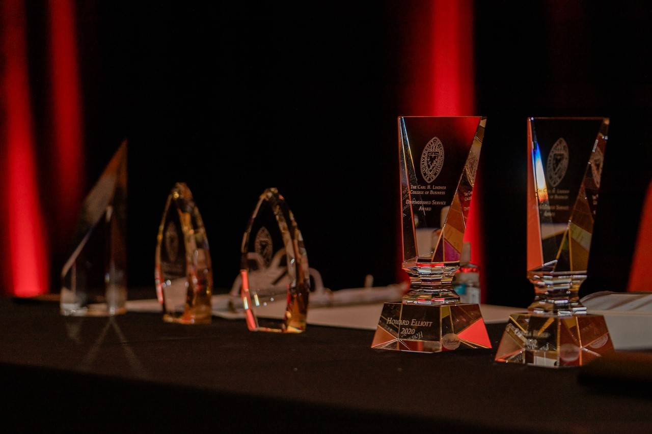 A group of trophies stand on a table.