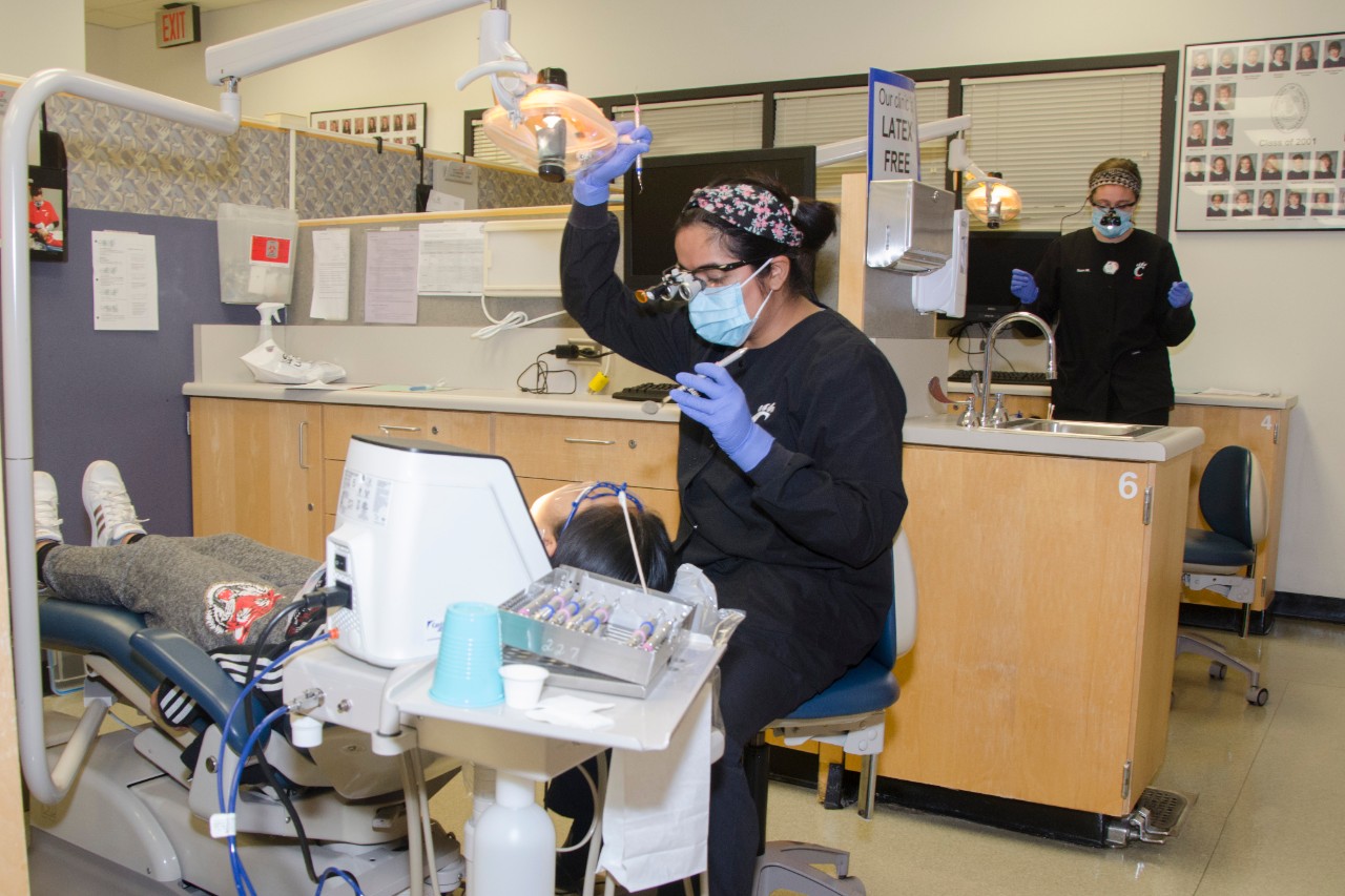 Dental Hygiene student working on a patient in the lab