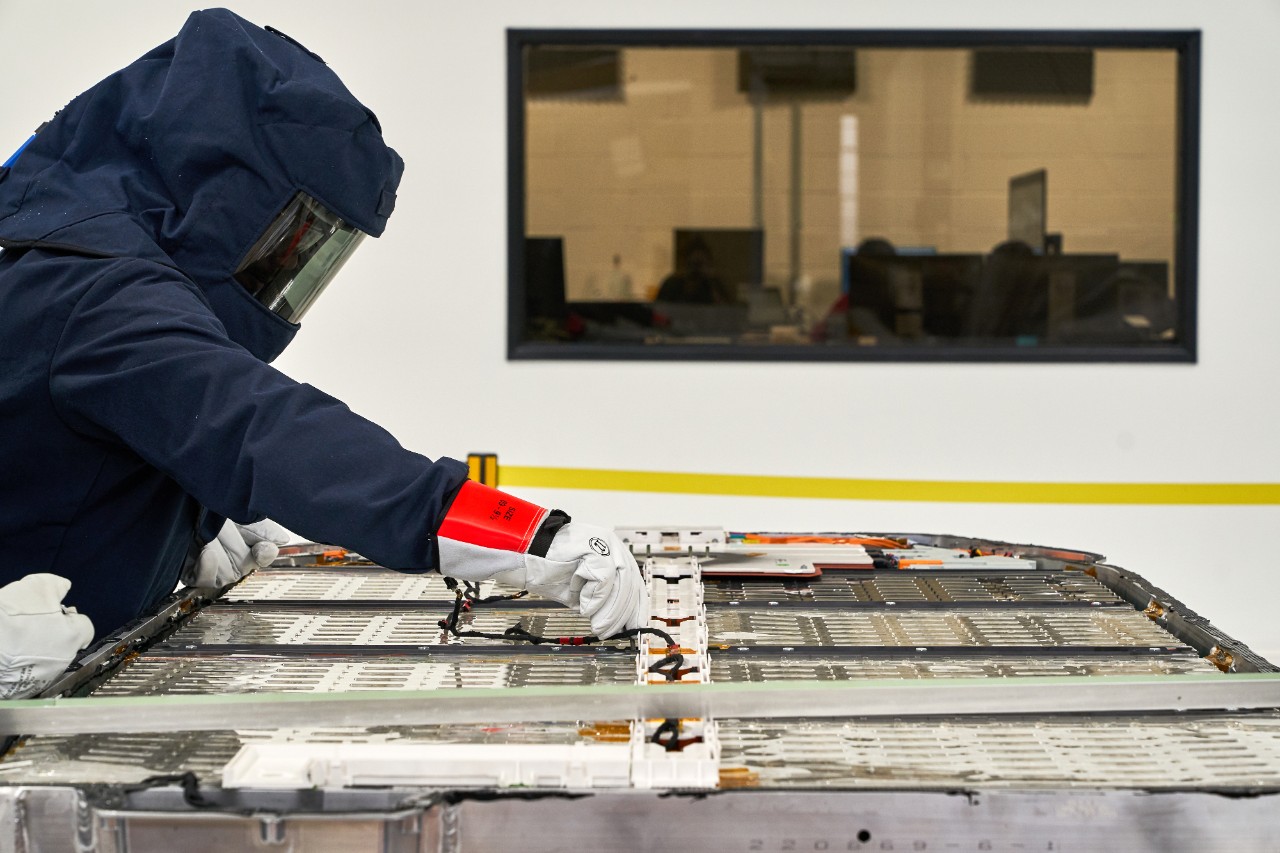 Rivian employee working with battery technology for electric adventure vehicles.