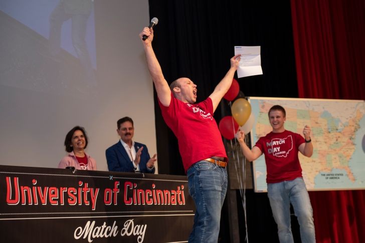 medical student celebrating on a stage