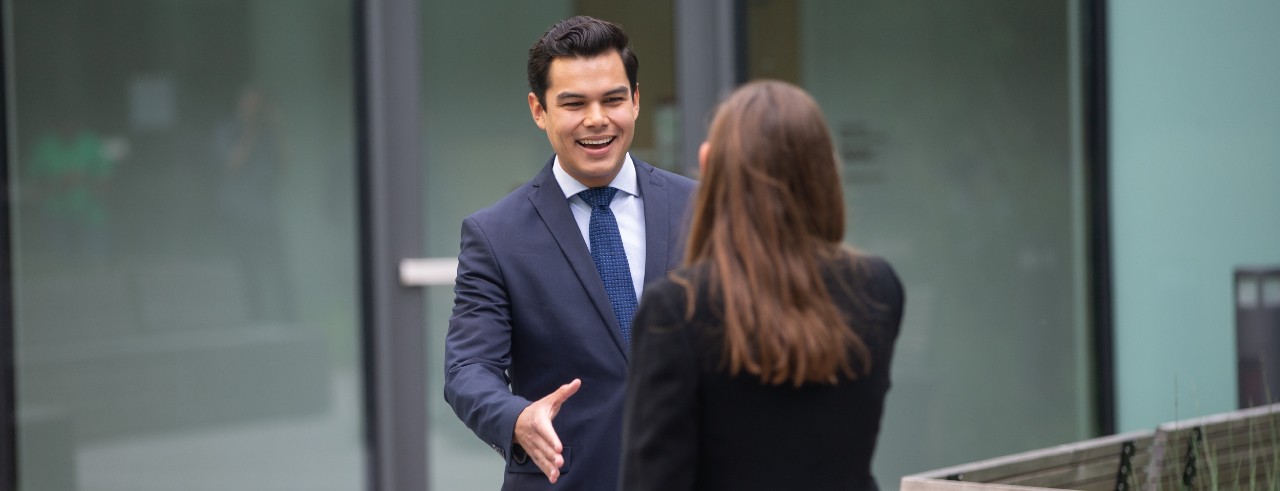 Business students shaking hands