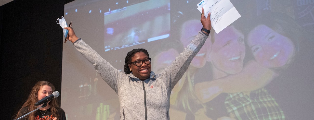 students raises arms in celebration