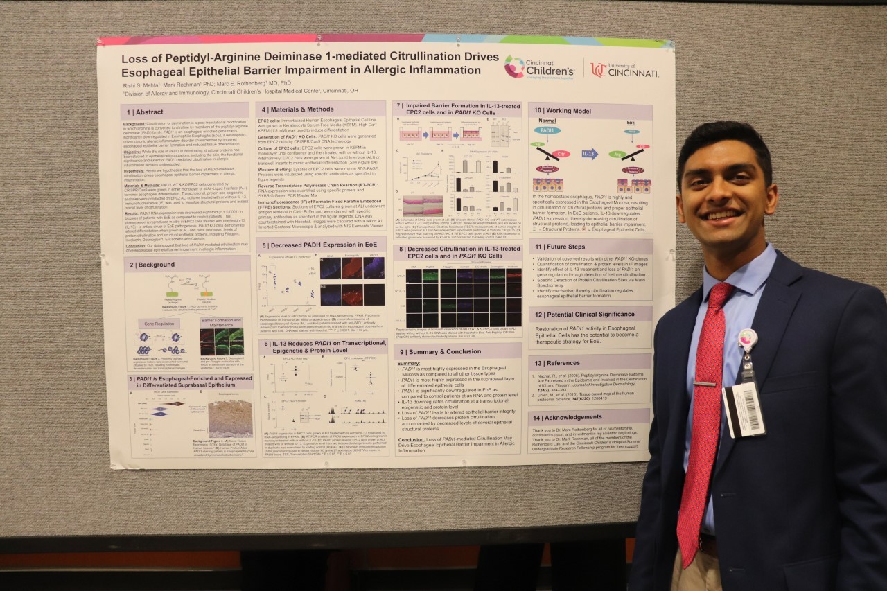 Rishi Mehta standing with a research poster