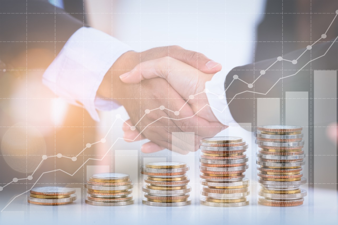 decorative image of people shaking hands and stacks of coins