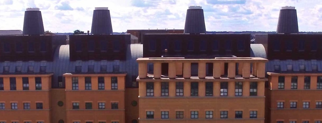 view of the top half of the Mantei Center, a brick building with four conical roof spires to resemble an engine's interior