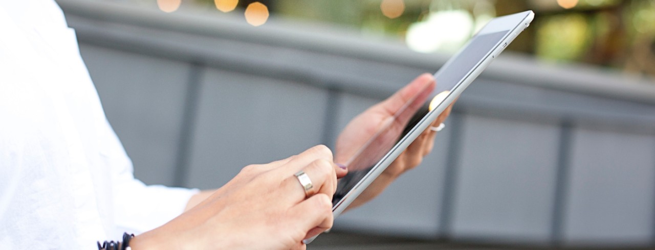 A person holds a tablet in their hands