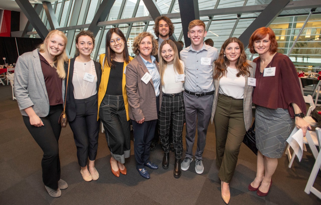 The Lindner dean and a professor pose with OBAIS students.