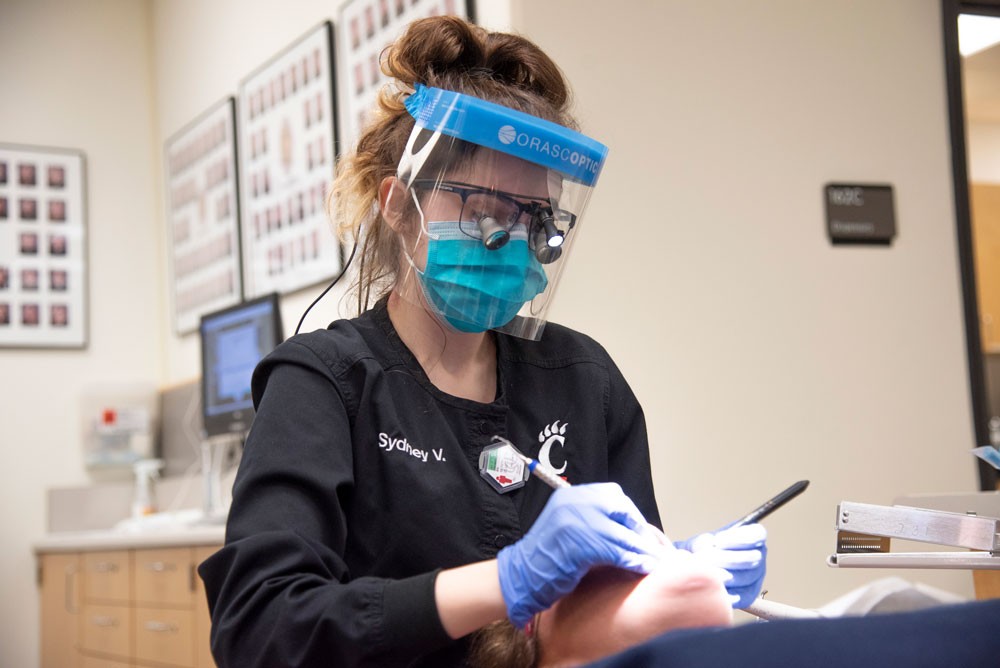 Dental Hygiene student Sydney Velazco working on a patient