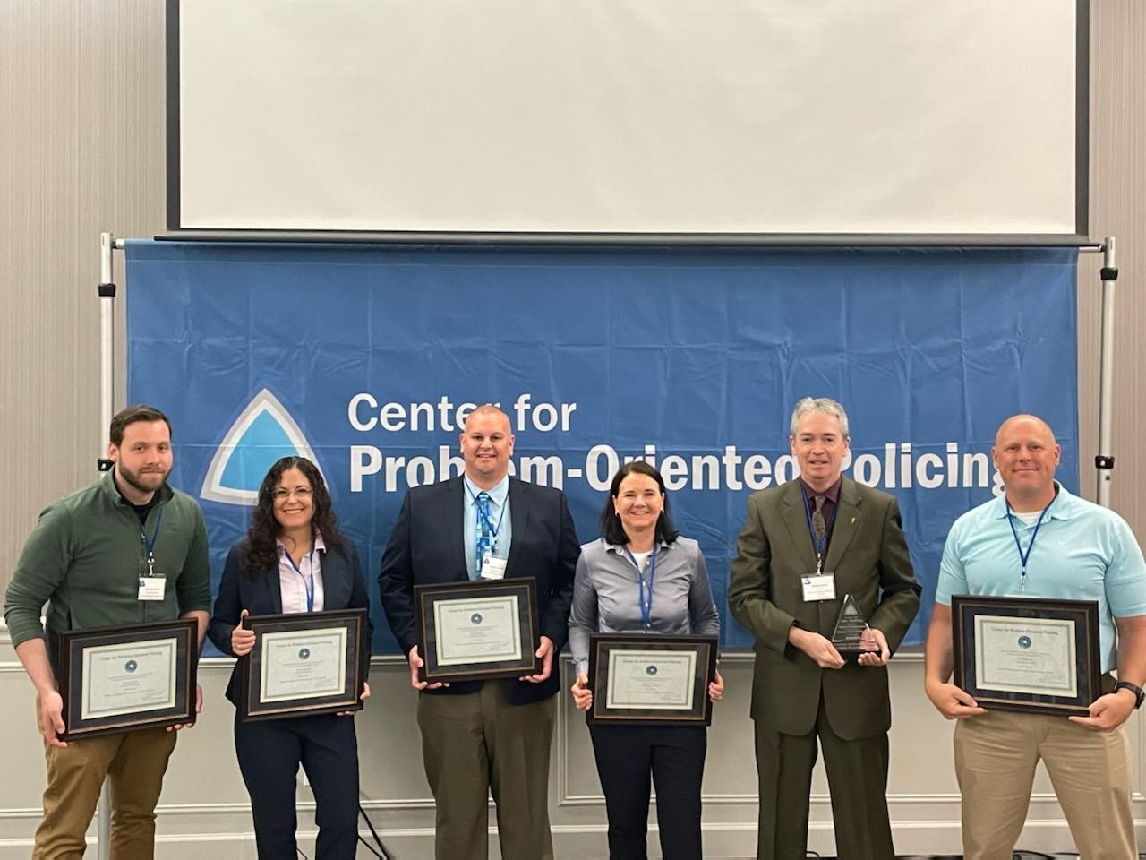 From left, UCPD Crime Analyst and Technical Lead Michael Zidar, Dr. Tamara Herold, UCPD Assistant Chief Dudley Smith, Boulder Police Chief Maris Herold, Center for Problem-Oriented Policing Director Michael Scott and UCPD Lt. David Brinker pose after UCPD was announced as this year's winner of the Herman Goldstein Award for Excellence in Problem-Oriented Policing.