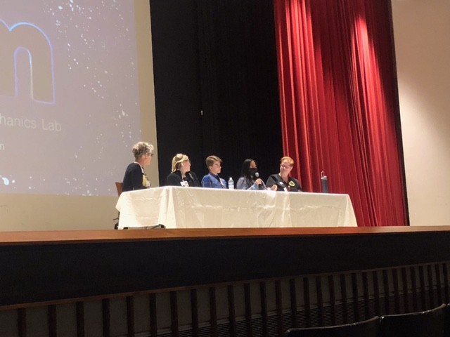 Panel speaking at event