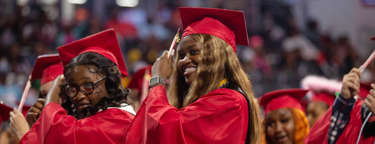 Benya Coleman shown during Hughes High School graduation turning her tassel.