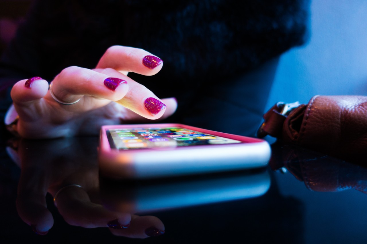 Female hand using a cellphone app