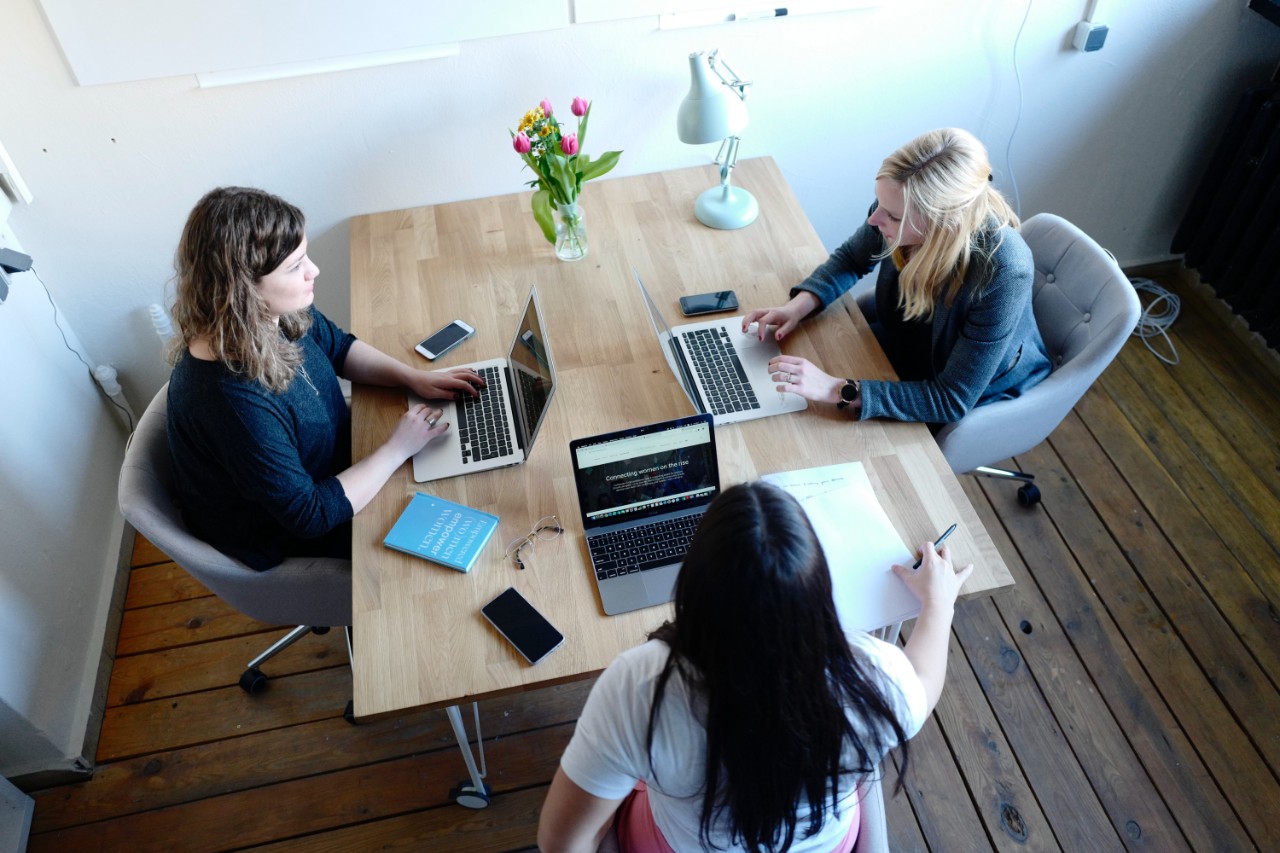 Lawyer or businesswoman sits with two colleagues or clients