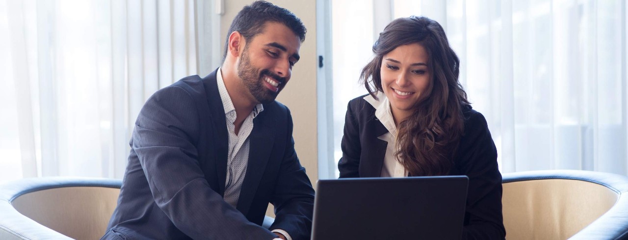 two people sitting at a computer