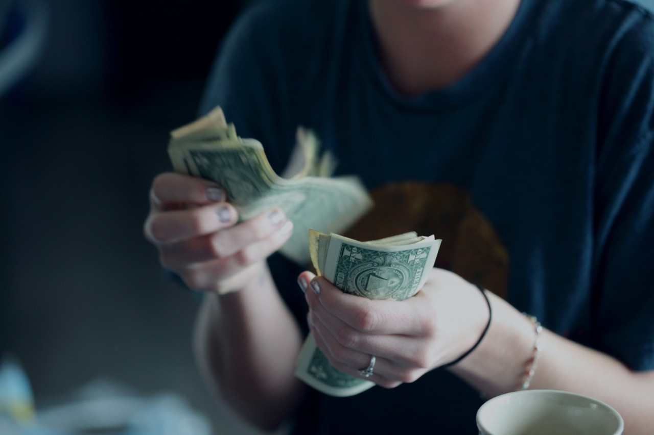 Person counting money.