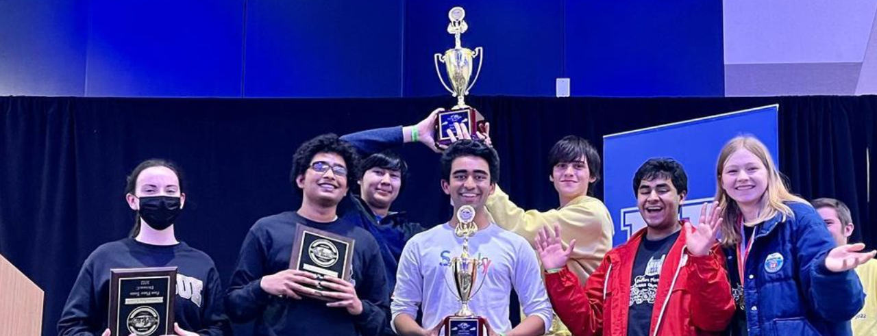 Sushruth Muthuluru and teammates hold up trophies and celebrate winning the Kentucky Science Olympiad competition