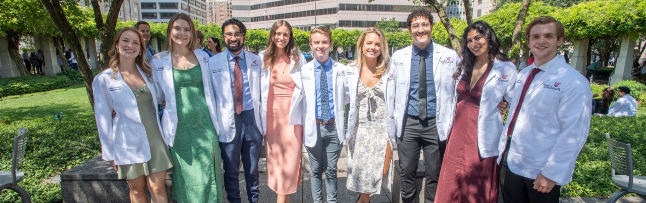 students standing in park with white coats