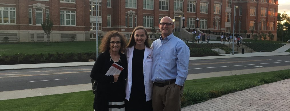 Lorrie, Ally and John Klaserner stand outside Kowalewski Hall on UC's medical campus
