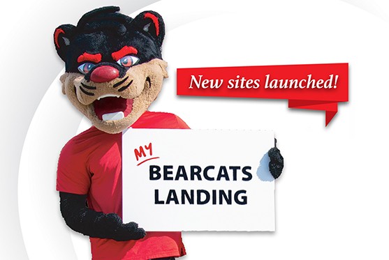 Laptop on a desk displaying Bearcat mascot holding a sign that reads "My Bearcats Landing"; banner announcing "New sites launched"