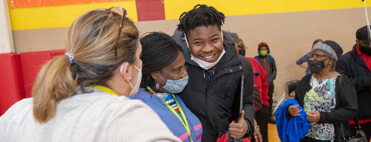 Jalen Tucker smiles in a school gymnasium.