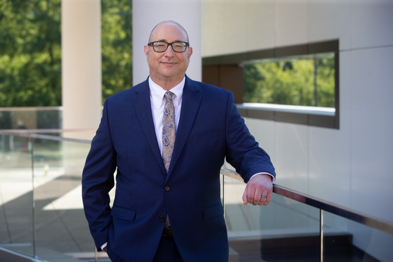 Incoming interim dean Michael Whiteman standing outside the new law building