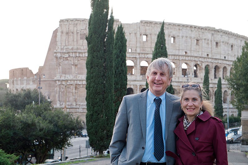 Jack Davis and Sharon Stocker pose in front of the ruins of the Colosseum.