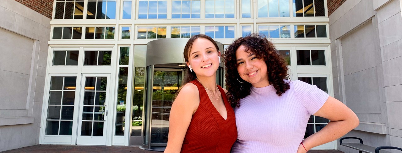 Aura Marquez and Mariela Luna Delgado stand outside the Teachers-Dyer building, where they performed research.