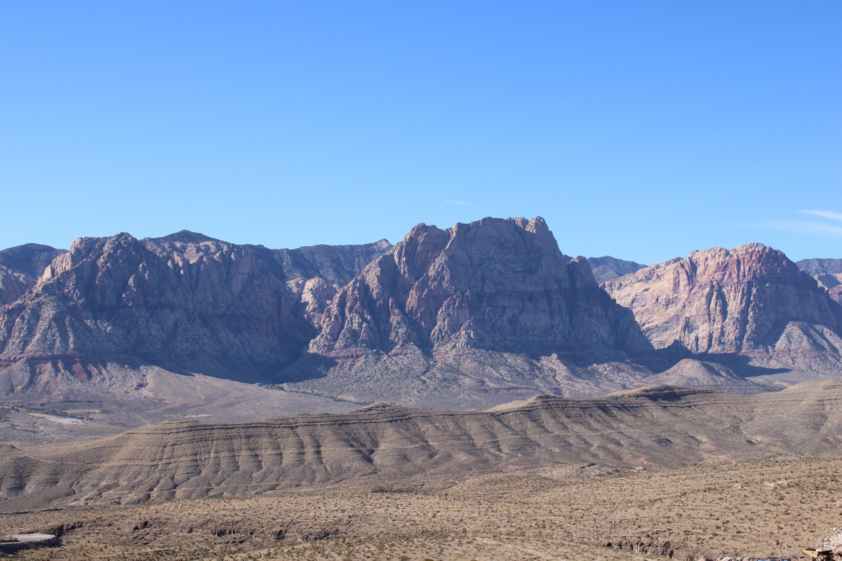 The Wilson Cliffs in Nevada against a blue sky and desert landscape.