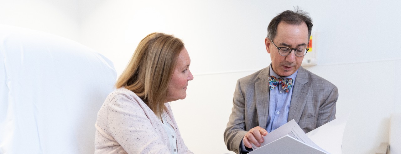 A patient talks with Dr. Michael Privitera in an exam room