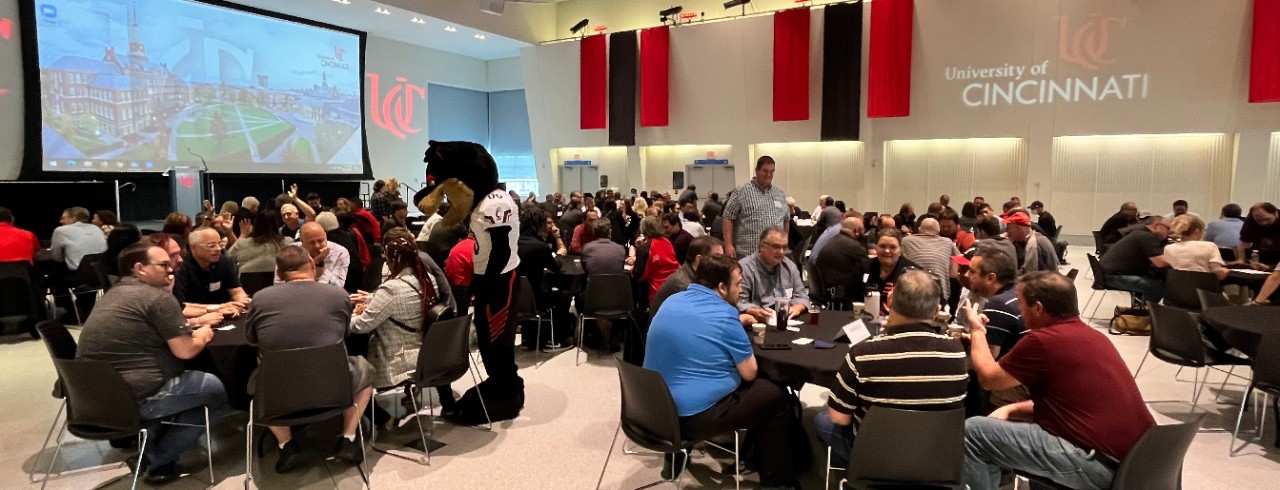 UC Bearcat visiting Digital Technology Solutions staff seated at tables in TUC's Great Hall
