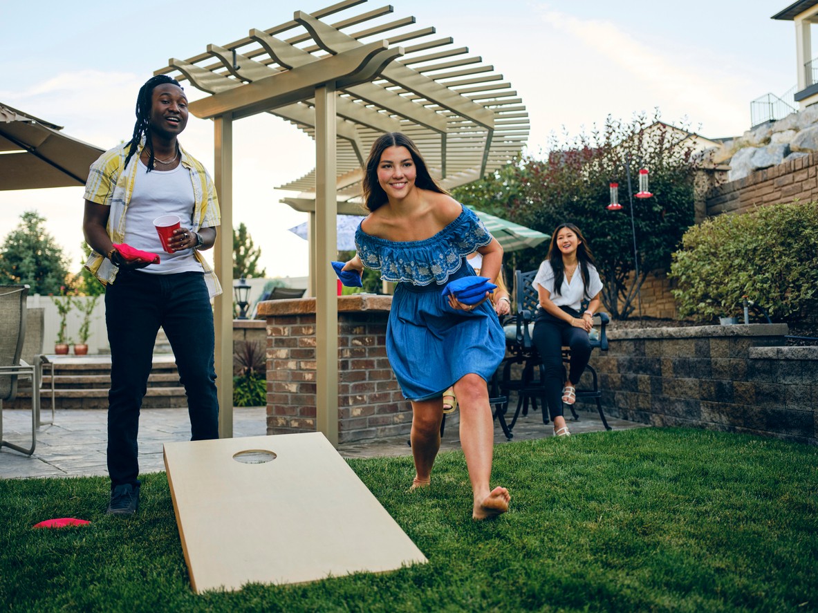 Students playing cornhole game